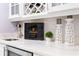 Close up of a wet bar area with a stainless steel sink, wine storage, and marble countertops at 1450 Belfiore Way, Windermere, FL 34786