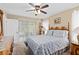 Comfortable bedroom with bright lighting, ceiling fan, and sliding glass doors to the outside at 1503 Canterbury Cir, Casselberry, FL 32707
