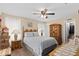 Bright bedroom featuring neutral walls, ceiling fan, and ample closet space at 1503 Canterbury Cir, Casselberry, FL 32707