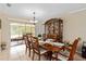 Charming dining area with an elegant wooden table, set for a meal, with views to a screened outdoor area at 1503 Canterbury Cir, Casselberry, FL 32707