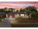 Charming single-story home featuring a well-manicured lawn, mature palm trees, and a cozy, inviting atmosphere at 1503 Canterbury Cir, Casselberry, FL 32707