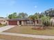 Well-maintained single-story home boasting an attached garage, mature landscaping, and inviting curb appeal in a neighborhood at 1503 Canterbury Cir, Casselberry, FL 32707