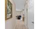 Hallway with tile flooring, art on the wall, and access to other rooms in the home at 1503 Canterbury Cir, Casselberry, FL 32707