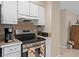 Updated kitchen featuring stainless steel range and white cabinets providing a functional cooking space at 1503 Canterbury Cir, Casselberry, FL 32707