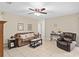 Comfortable living room with tile flooring, ceiling fan, and neutral decor, creating a welcoming and relaxing space at 1503 Canterbury Cir, Casselberry, FL 32707