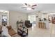 Inviting open-concept living area with tile floors, a ceiling fan, and access to the kitchen and outdoor patio at 1503 Canterbury Cir, Casselberry, FL 32707
