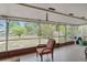 Relaxing screened patio with outdoor seating overlooks the private fenced backyard surrounded by mature trees and landscaping at 1503 Canterbury Cir, Casselberry, FL 32707