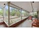 Relaxing screened patio with outdoor seating overlooks the private fenced backyard surrounded by mature trees and landscaping at 1503 Canterbury Cir, Casselberry, FL 32707