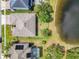 Bird's eye view showcases a private backyard next to a shimmering lake at 16313 Birchwood Way, Orlando, FL 32828