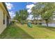 Spacious backyard with lawn and view of pond, perfect for outdoor relaxation at 16313 Birchwood Way, Orlando, FL 32828
