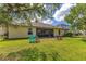 Large backyard featuring lawn, seating, and view of house with screened in porch at 16313 Birchwood Way, Orlando, FL 32828
