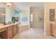 Elegant bathroom featuring a soaking tub, glass shower, double vanity, and a bright window at 16313 Birchwood Way, Orlando, FL 32828