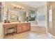 Spa-like primary bathroom with a soaking tub, glass shower, double vanity, and tile flooring at 16313 Birchwood Way, Orlando, FL 32828