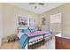 Cozy bedroom with metal bed frame, hardwood floors, and decorative accents at 16313 Birchwood Way, Orlando, FL 32828