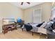 Well-lit bedroom features neutral walls, hardwood floors, TV and desk area at 16313 Birchwood Way, Orlando, FL 32828