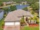 Stunning home showcasing a beautiful pond view, well-manicured landscaping, and an inviting two-car garage at 16313 Birchwood Way, Orlando, FL 32828