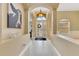 Inviting foyer featuring a grand arched entryway, high ceilings, and decorative chandelier at 16313 Birchwood Way, Orlando, FL 32828