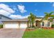 Charming single-Gathering home featuring a three-car garage, landscaped yard, and tropical palm trees at 16313 Birchwood Way, Orlando, FL 32828