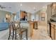 Open-concept kitchen featuring a breakfast bar, granite countertops, and modern appliances at 16313 Birchwood Way, Orlando, FL 32828