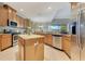 Bright kitchen featuring an island, granite countertops, stainless steel appliances and light wood flooring at 16313 Birchwood Way, Orlando, FL 32828