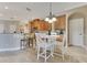 Eat-in kitchen area featuring a breakfast bar, white wood table and chairs, and light wood flooring at 16313 Birchwood Way, Orlando, FL 32828