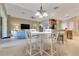 Open-concept living area featuring a white wood table and chairs, tile flooring, and a view of the living room at 16313 Birchwood Way, Orlando, FL 32828