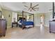 Light and airy main bedroom featuring a canopy bed, ceiling fan, and views of the backyard at 16313 Birchwood Way, Orlando, FL 32828
