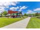 Vibrant playground with colorful shade canopies surrounded by green space at 16313 Birchwood Way, Orlando, FL 32828
