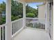Charming balcony view featuring classic white columns and railing overlooking lush landscaping at 171 Mcleods Way, Winter Springs, FL 32708