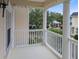 Inviting balcony with white railing and columns, offering a serene outdoor space to enjoy the neighborhood view at 171 Mcleods Way, Winter Springs, FL 32708
