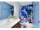 bathroom with blue walls, playful sea-themed shower curtain, and matching decor at 171 Mcleods Way, Winter Springs, FL 32708