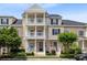 Inviting multi-level townhome featuring a porch and balconies, nestled in a beautifully landscaped community at 171 Mcleods Way, Winter Springs, FL 32708
