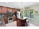Well-lit kitchen with a large window, granite countertops, and stainless-steel appliances at 171 Mcleods Way, Winter Springs, FL 32708