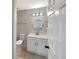 Clean bathroom with a new vanity, toilet, towel rack, and modern mirror and lighting at 17505 Silver Creek Ct, Clermont, FL 34714