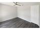 This bedroom features a ceiling fan and closet, plus stylish gray wood-look floors and neutral walls at 17505 Silver Creek Ct, Clermont, FL 34714