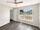 Bright bedroom with large window, ceiling fan, and stylish gray wood-look floors at 17505 Silver Creek Ct, Clermont, FL 34714