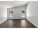 Bright bedroom featuring modern flooring and a large window overlooking the backyard at 17505 Silver Creek Ct, Clermont, FL 34714