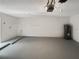 Spacious garage with gray painted floor and white walls with storage, ready for parking and projects at 17505 Silver Creek Ct, Clermont, FL 34714