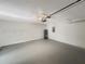 Spacious two-car garage featuring painted walls and a water heater at 17505 Silver Creek Ct, Clermont, FL 34714