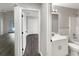 Bright hallway view showcasing modern bathroom, bedroom entrance, and waterproof vinyl flooring at 17505 Silver Creek Ct, Clermont, FL 34714