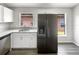 Open kitchen layout with stainless steel appliances, white cabinets, and views from dual windows at 17505 Silver Creek Ct, Clermont, FL 34714