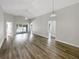 Bright and airy living room with wood-look floors and access to the screened-in pool area at 17505 Silver Creek Ct, Clermont, FL 34714