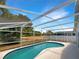 Backyard pool with a screen, surrounded by lush greenery and a serene atmosphere at 17505 Silver Creek Ct, Clermont, FL 34714