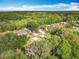 Overhead view of the neighborhood surrounded by lush trees and canopy at 185 Poinciana Ln, Deltona, FL 32738