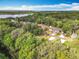 Drone shot of property with expansive wooded area and waterfront access at 185 Poinciana Ln, Deltona, FL 32738
