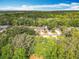 Aerial view of home surrounded by beautiful canopy and mature trees at 185 Poinciana Ln, Deltona, FL 32738