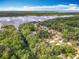 Picturesque aerial of homes near a serene lake showcasing the lush, green landscape at 185 Poinciana Ln, Deltona, FL 32738