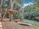 Backyard showing a wooden treehouse and a boat along a creek at 185 Poinciana Ln, Deltona, FL 32738
