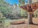 Backyard view showing a treehouse, small boats, and a peaceful creek at 185 Poinciana Ln, Deltona, FL 32738