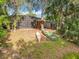 Beautiful backyard view of screened-in lanai with a boat house and waterfront access at 185 Poinciana Ln, Deltona, FL 32738